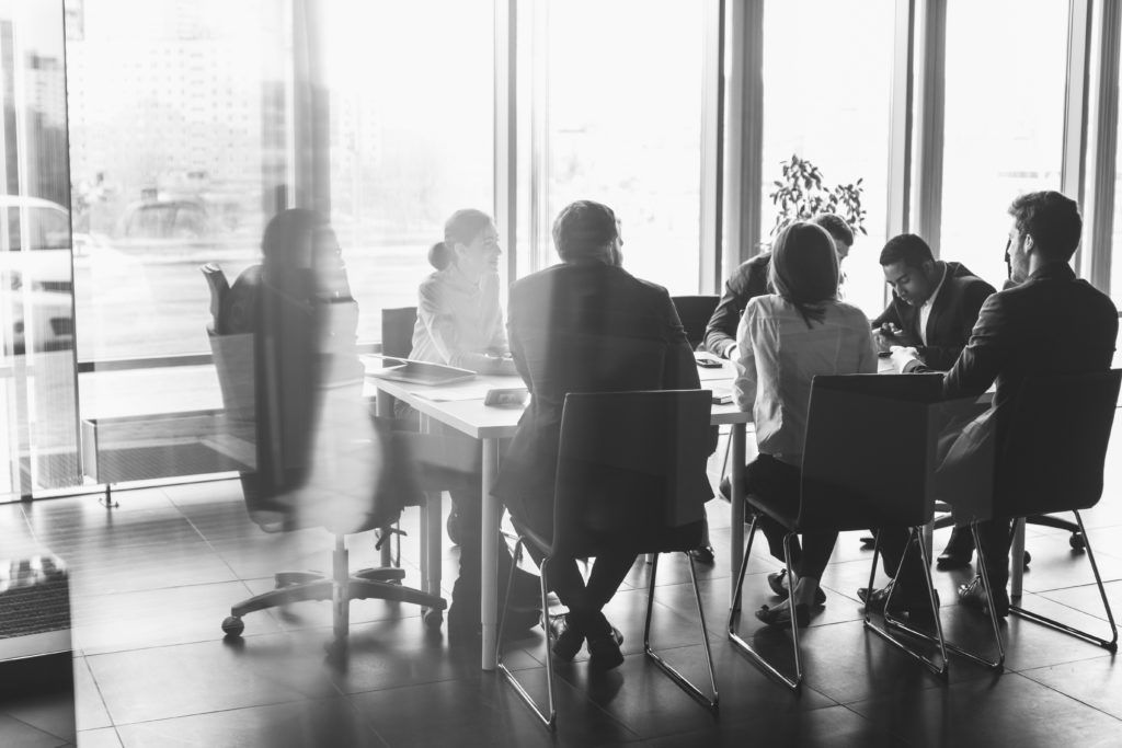 people talking at desk in office