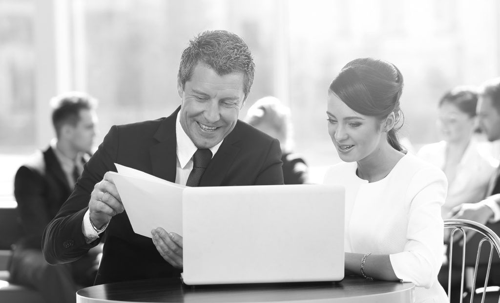 consultants working together on laptop
