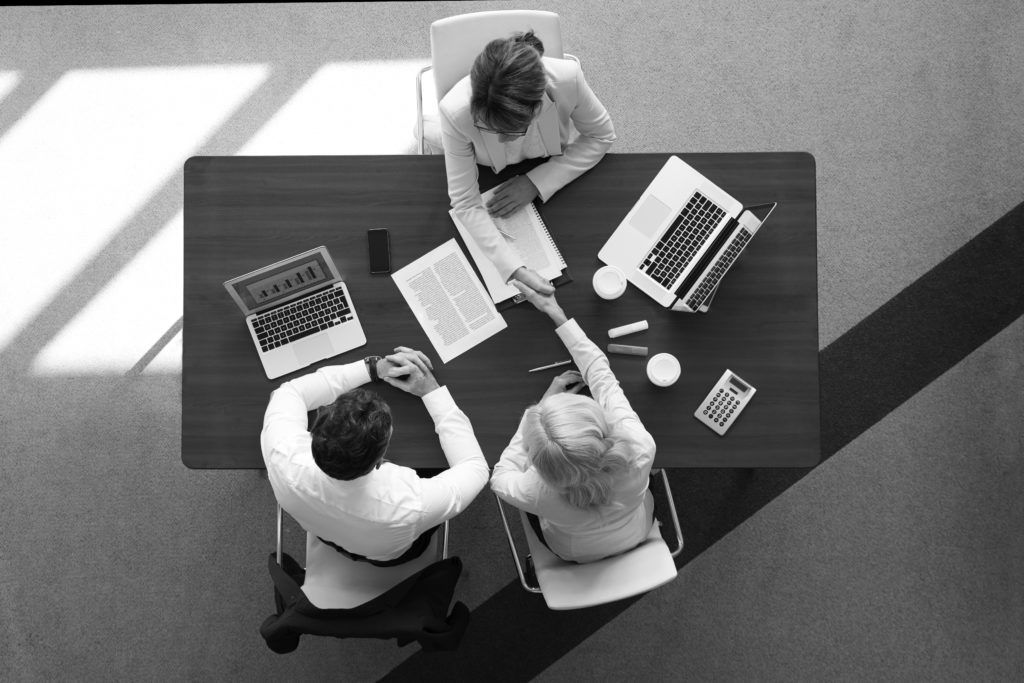 people talking at desk in office