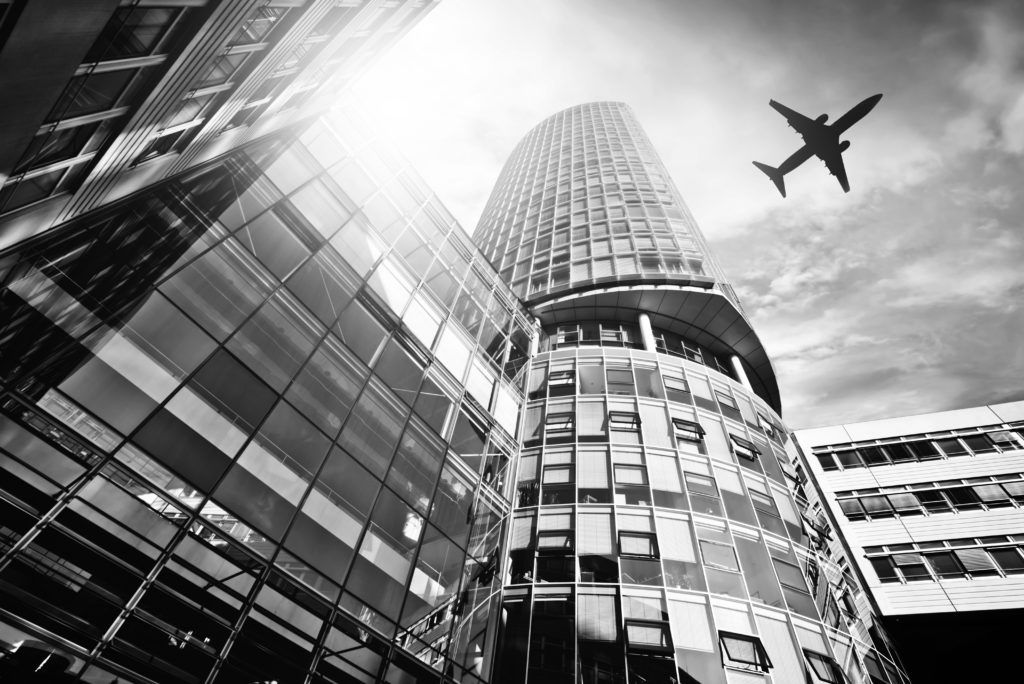 building with airplane flying overhead