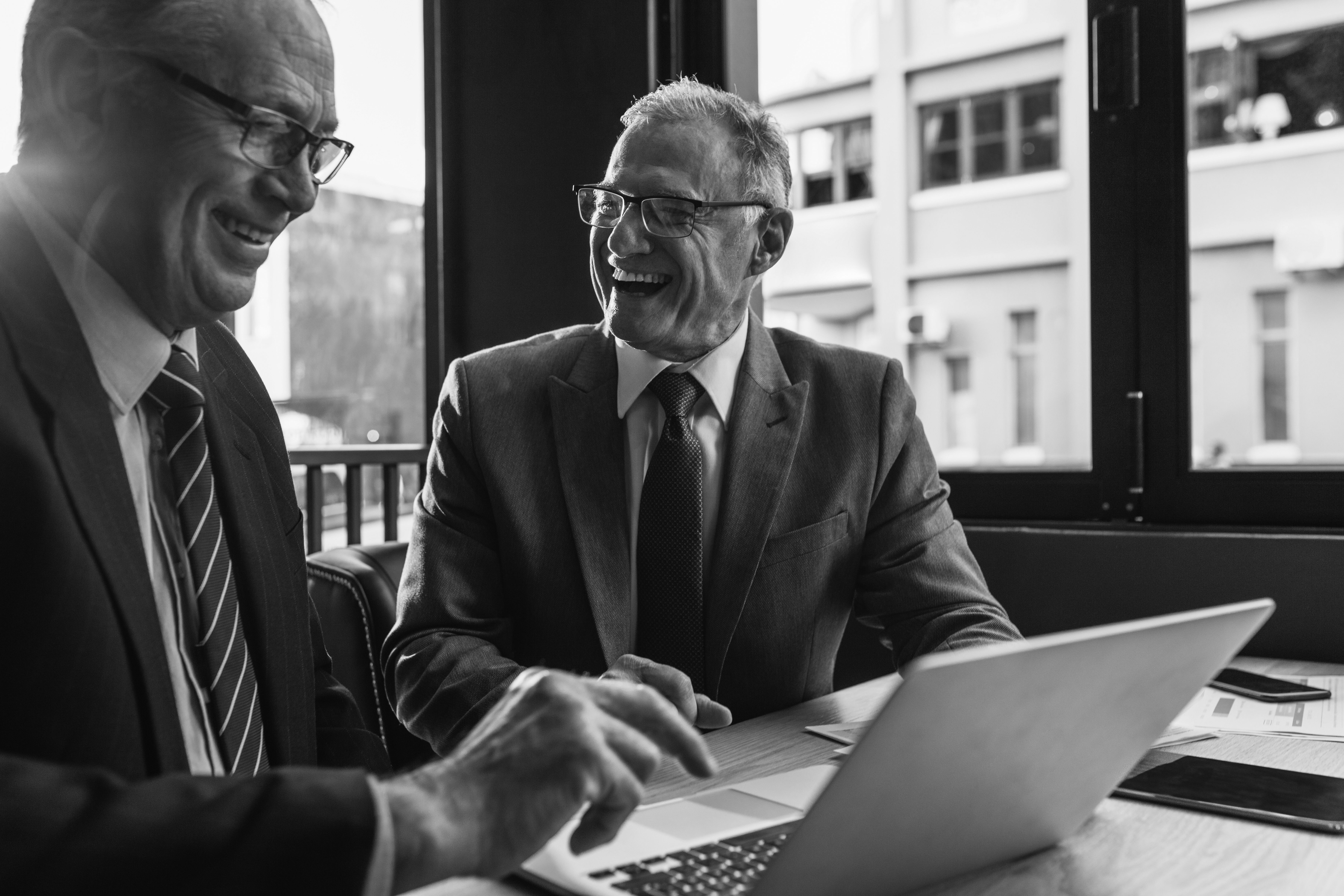 consultants working together on laptop