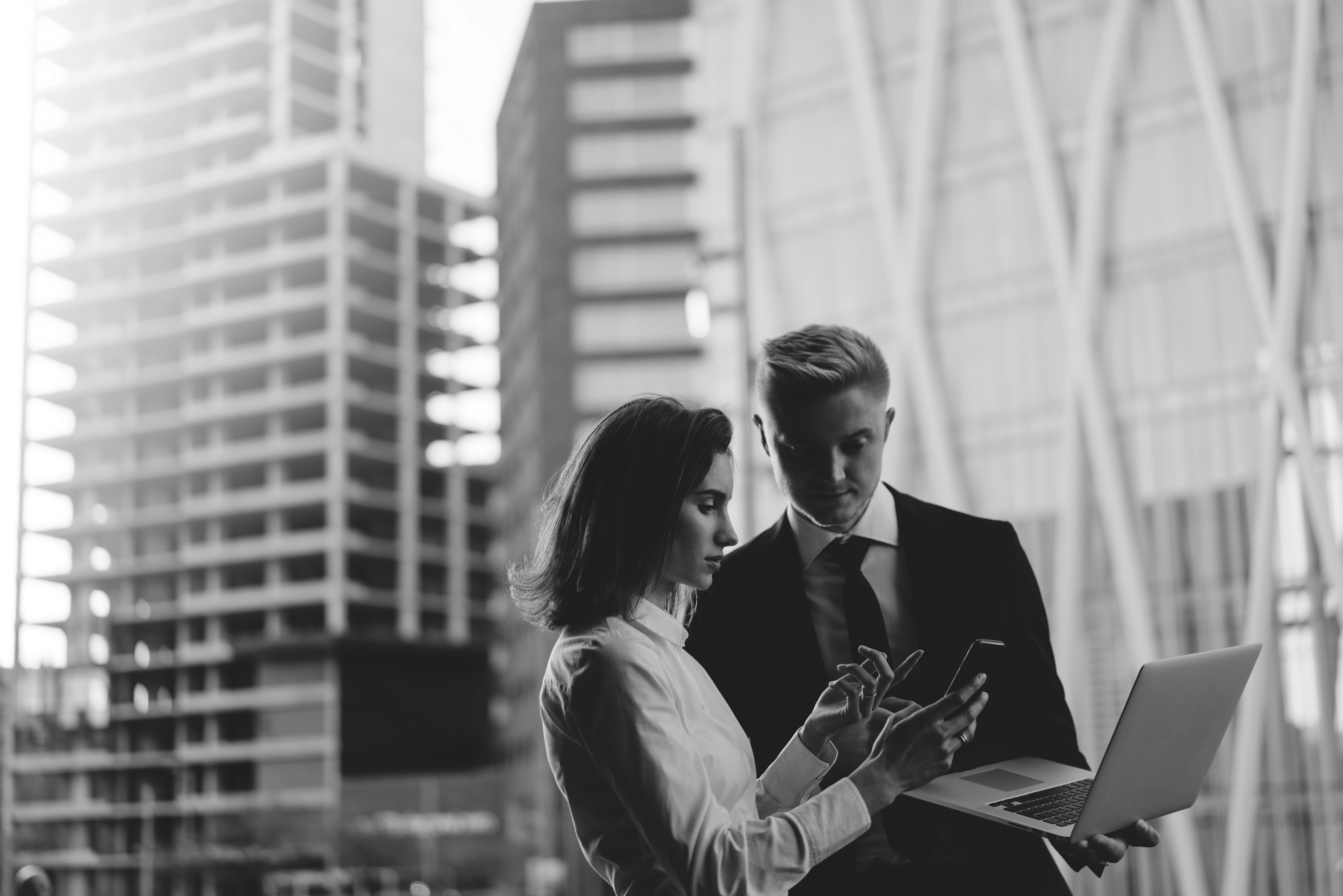 consultants working with buildings in the background