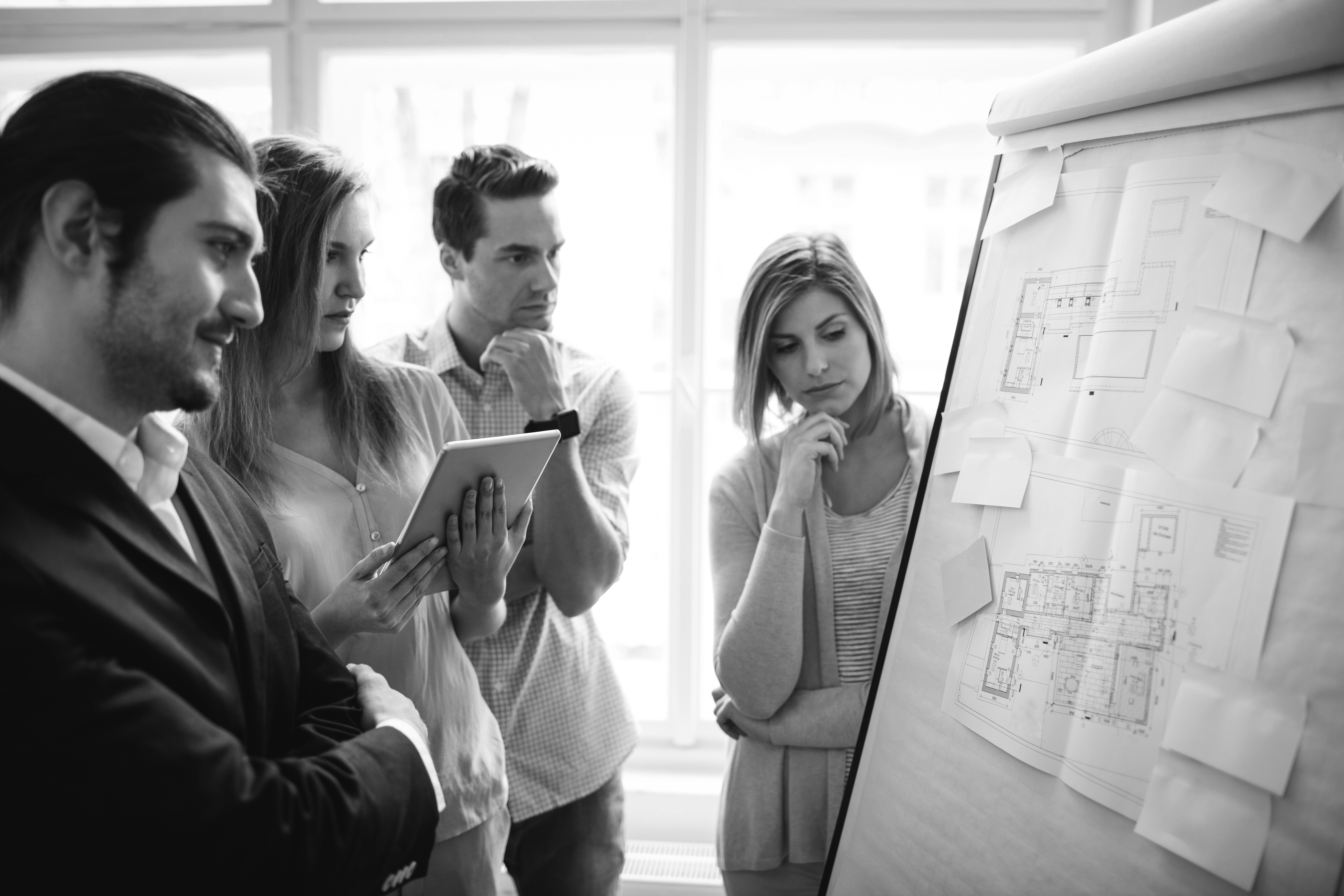 consultants working in office looking in flipchart