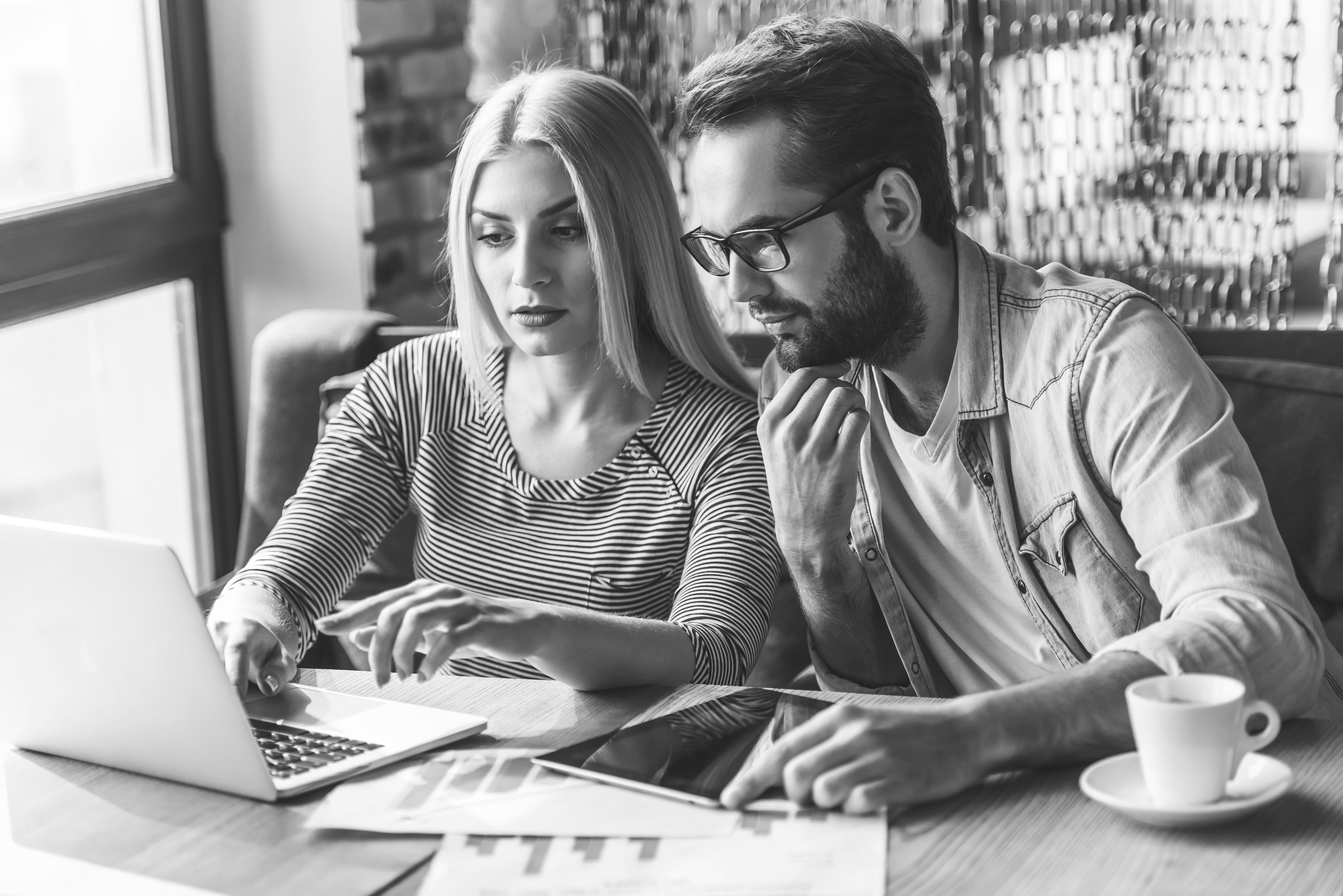 consultants working on laptop in restaurant