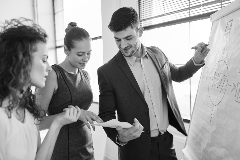 consultant writing on flipchart