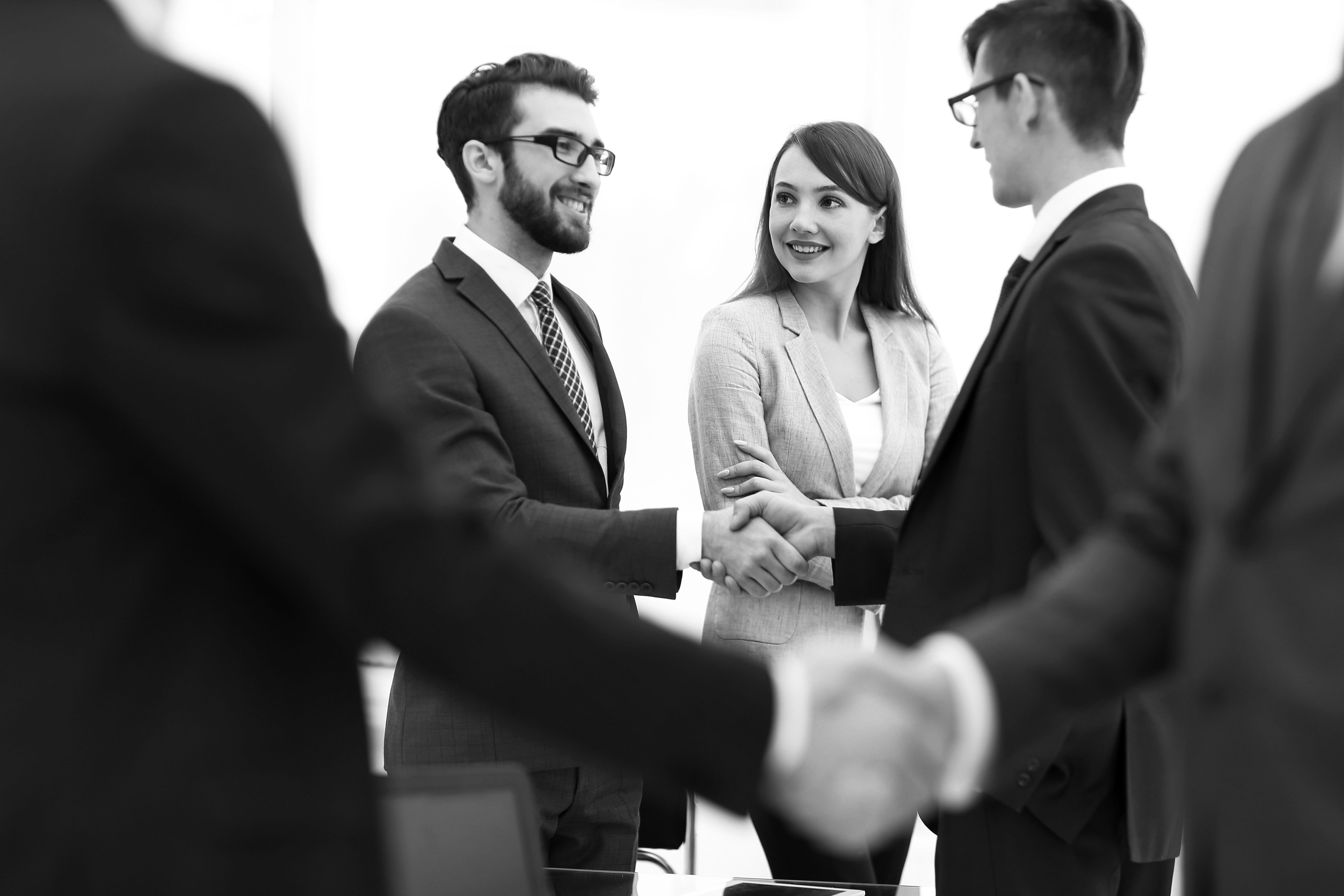 consultants working in office shaking hands