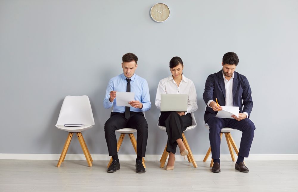 Group of three independent contractors sitting and waiting for an interview.